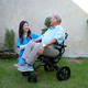 Nurse helps elderly man in wheelchair enjoy time in garden during sunny afternoon Nurse helps elderly man in wheelchair enjoy time in garden during sunny afternoon - PhotoDune Item for Sale