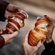 Close-up of couple's hands with croissant Close-up of couple's hands with croissant - PhotoDune Item for Sale