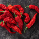Hot Bih Jolokia peppers atop dark textured backdrop, top view; Hot Bih Jolokia peppers atop dark textured backdrop, top view; - PhotoDune Item for Sale
