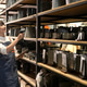 Young woman in apron scanning items on shelves with barcode scanner and tablet Young woman in apron scanning items on shelves with barcode scanner and tablet - PhotoDune Item for Sale