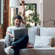 Successful young man using her laptop and celebrating something while sitting on sofa at home. Successful young man using her laptop and celebrating something while sitting on sofa at home. - PhotoDune Item for Sale