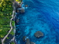 Aerial view Top down seashore. Waves crashing on rock cliff. Beautiful dark sea surface in sunny day Aerial view Top down seashore. Waves crashing on rock cliff. Beautiful dark sea surface in sunny day - PhotoDune Item for Sale