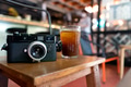 Vintage camera and ice brew coffee on wooden table Vintage camera and ice brew coffee on wooden table - PhotoDune Item for Sale