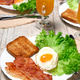 Breakfast: fried egg, lettuce, toasted bread, fried bacon and orange juice. Breakfast: fried egg, lettuce, toasted bread, fried bacon and orange juice. - PhotoDune Item for Sale