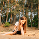 Little girl with dark hair sit on sand near forest. Female child in white t-shirt and black shorts Little girl with dark hair sit on sand near forest. Female child in white t-shirt and black shorts - PhotoDune Item for Sale