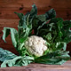 Fresh cauliflower head with green leaves on wood surface Fresh cauliflower head with green leaves on wood surface - PhotoDune Item for Sale