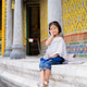 Radiant young Thai girl in traditional silver Sbai costume sitting by a temple pillar. Radiant young Thai girl in traditional silver Sbai costume sitting by a temple pillar. - PhotoDune Item for Sale