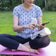 Woman Using Smartphone to Select VR Application Sitting on Yoga Mat Outdoors Woman Using Smartphone to Select VR Application Sitting on Yoga Mat Outdoors - PhotoDune Item for Sale