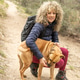 Curly hair and mountaineer woman and her dog posing outdoor during his walk through the mountains. Curly hair and mountaineer woman and her dog posing outdoor during his walk through the mountains. - PhotoDune Item for Sale
