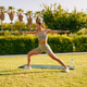 A Woman Practicing Yoga Outdoors in Stylish Modern Athletic Wear in a Beautiful Setting A Woman Practicing Yoga Outdoors in Stylish Modern Athletic Wear in a Beautiful Setting - PhotoDune Item for Sale