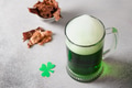 Patrick's day green beer in pint and jerky on gray background. Patrick's day green beer in pint and jerky on gray background. - PhotoDune Item for Sale
