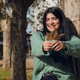 young woman in the park laughing with a dry autumn leaf young woman in the park laughing with a dry autumn leaf - PhotoDune Item for Sale