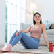Happy woman sitting on floor after exercise Happy woman sitting on floor after exercise - PhotoDune Item for Sale