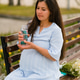 Pregnant woman drinking water from reusable glass bottle outdoor.Hydration during pregnancy concept Pregnant woman drinking water from reusable glass bottle outdoor.Hydration during pregnancy concept - PhotoDune Item for Sale