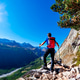 Hiker takes a rest observing a mountain panorama. Mont Blanc Massif, Italian Alps, Hiker takes a rest observing a mountain panorama. Mont Blanc Massif, Italian Alps, - PhotoDune Item for Sale