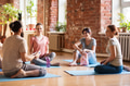group of people resting on yoga mats at studio group of people resting on yoga mats at studio - PhotoDune Item for Sale
