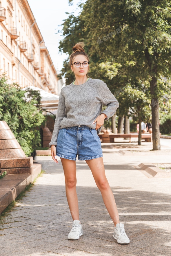 Street summer fashion portrait of young millennial girl in glasses
