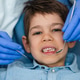 Examining a boys teeth during a dental checkup prevents cavities and promotes oral health. Examining a boys teeth during a dental checkup prevents cavities and promotes oral health. - PhotoDune Item for Sale