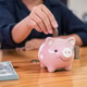 Woman putting coins into piggy bank planning growing saving to strategy with money box for future Woman putting coins into piggy bank planning growing saving to strategy with money box for future - PhotoDune Item for Sale
