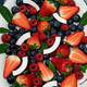 A plate of fresh, ripe berries: blueberries, strawberries, raspberries, cut coconut, mint leaves. A plate of fresh, ripe berries: blueberries, strawberries, raspberries, cut coconut, mint leaves. - PhotoDune Item for Sale