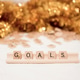 Scrabble letter goals with gold glitter in background. Scrabble letter goals with gold glitter in background. - PhotoDune Item for Sale