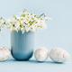 Easter greeting card with snowdrops in a vase and Easter eggs on a light blue background. Copy space Easter greeting card with snowdrops in a vase and Easter eggs on a light blue background. Copy space - PhotoDune Item for Sale