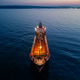 Aerial View of Industrial Tanker Ship at Sea During Sunset with City Lights Aerial View of Industrial Tanker Ship at Sea During Sunset with City Lights - PhotoDune Item for Sale