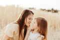 Two sisters little girls wear casual dresses having fun in wheat field. Yellow color, family Two sisters little girls wear casual dresses having fun in wheat field. Yellow color, family - PhotoDune Item for Sale
