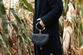Stylish woman in black coat in autumn corn field Stylish woman in black coat in autumn corn field - PhotoDune Item for Sale