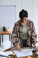 Architect woman standing in office working on new project. Architect woman standing in office working on new project. - PhotoDune Item for Sale