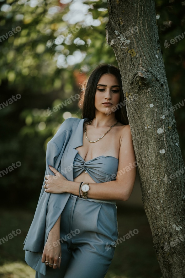 Sexy female from Bosnia and Herzegovina in a trendy blue suit posing in the forest Stock Photo by wirestock Sexy female from Bosnia and Herzegovina in a trendy blue suit posing in the forest Stock Photo by wirestock