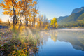 Landscape during sunrise. Autumn trees on the river bank. Sunlight through the trees. Landscape during sunrise. Autumn trees on the river bank. Sunlight through the trees. - PhotoDune Item for Sale
