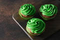 Chocolate cupcake with green whipped cream. St. Patrick's Day celebration. Chocolate cupcake with green whipped cream. St. Patrick's Day celebration. - PhotoDune Item for Sale