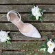 White wedding shoe with white flowers on old wooden boards White wedding shoe with white flowers on old wooden boards - PhotoDune Item for Sale