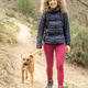 Curly and blonde hair, mountaineer woman and her dog walking through the mountains. Curly and blonde hair, mountaineer woman and her dog walking through the mountains. - PhotoDune Item for Sale