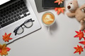 Laptop computer, coffee cup, glasses, books and autumn maple leaves on white table. Laptop computer, coffee cup, glasses, books and autumn maple leaves on white table. - PhotoDune Item for Sale