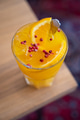 Close-up of a tasty drink with turmeric, honey, ginger and orange topped with pink pepper corns Close-up of a tasty drink with turmeric, honey, ginger and orange topped with pink pepper corns - PhotoDune Item for Sale