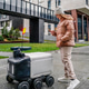 Autonomous delivery robot moves on wet sidewalk. Smartphone app tracking parcel, contactless Autonomous delivery robot moves on wet sidewalk. Smartphone app tracking parcel, contactless - PhotoDune Item for Sale
