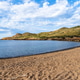 Scenic view of a beach in Menorca with clear blue water and a cloudy sky. Scenic view of a beach in Menorca with clear blue water and a cloudy sky. - PhotoDune Item for Sale