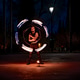 Fire performer juggling burning poi in a night park show Fire performer juggling burning poi in a night park show - PhotoDune Item for Sale