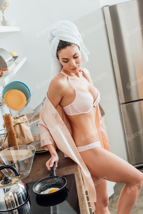 Sexy young woman in lingerie with towel on head cooking fried egg in kitchen Stock Photo by LightFieldStudios Sexy young woman in lingerie with towel on head cooking fried egg in kitchen Stock Photo by LightFieldStudios