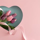 Tulip Bouquet in Heart Cutout. Romantic Valentines Day Flatlay with Ribbon on Pink Background Tulip Bouquet in Heart Cutout. Romantic Valentines Day Flatlay with Ribbon on Pink Background - PhotoDune Item for Sale