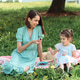 Mom and daughter eat cherries on a picnic in the park on a summer day. Mom and daughter eat cherries on a picnic in the park on a summer day. - PhotoDune Item for Sale