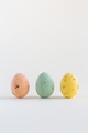 Three beautiful pastel colored chocolate Easter eggs on a white background with copy space Three beautiful pastel colored chocolate Easter eggs on a white background with copy space - PhotoDune Item for Sale