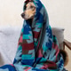 spotted dog wrapped in blanket is sitting on couch. blanket is blue and red, Christmas ornament. spotted dog wrapped in blanket is sitting on couch. blanket is blue and red, Christmas ornament. - PhotoDune Item for Sale