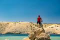 Mountain biker looking at mountains and beach Mountain biker looking at mountains and beach - PhotoDune Item for Sale