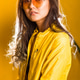 A close-up portrait of a girl wearing yellow glasses on a yellow background, looking at the camera A close-up portrait of a girl wearing yellow glasses on a yellow background, looking at the camera - PhotoDune Item for Sale