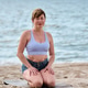 Adult woman practicing yoga on sandy beach by Baltic Sea in calm daylight Adult woman practicing yoga on sandy beach by Baltic Sea in calm daylight - PhotoDune Item for Sale