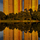 Reflection of a multi-story building in the water of the reservoir in the yellow warm light of the e Reflection of a multi-story building in the water of the reservoir in the yellow warm light of the e - PhotoDune Item for Sale