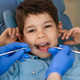 A dentist examines a boys teeth to prevent cavities and promote oral health A dentist examines a boys teeth to prevent cavities and promote oral health - PhotoDune Item for Sale